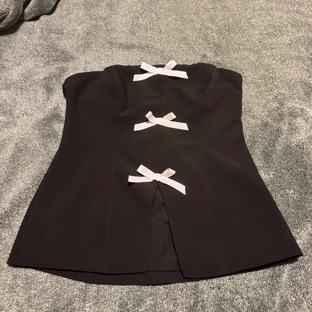 Black strapless top with bows